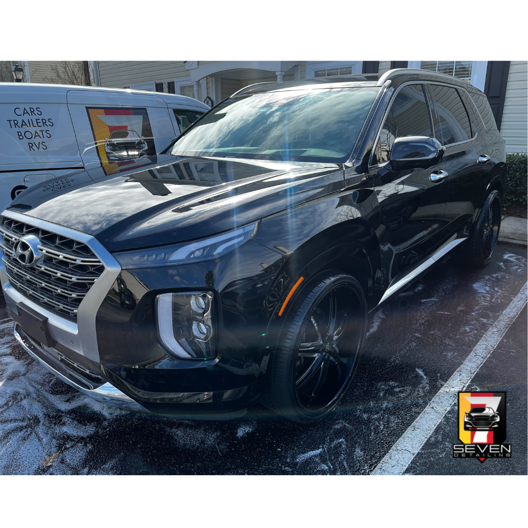 A black, Hyundai, SUV detailed by a mobile detailing company.