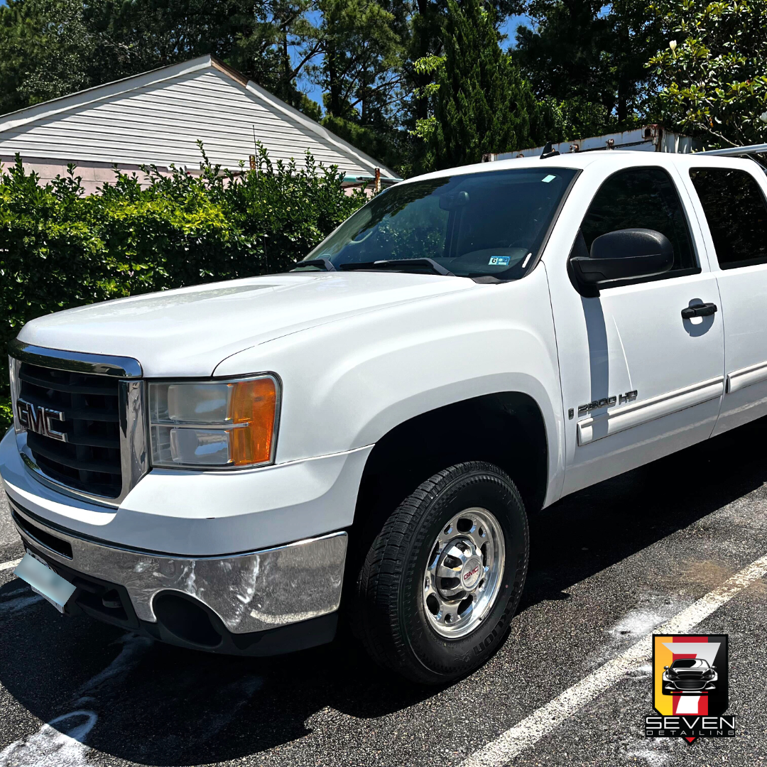 A white, GMC, SUV, detailed by a mobile detailing company.