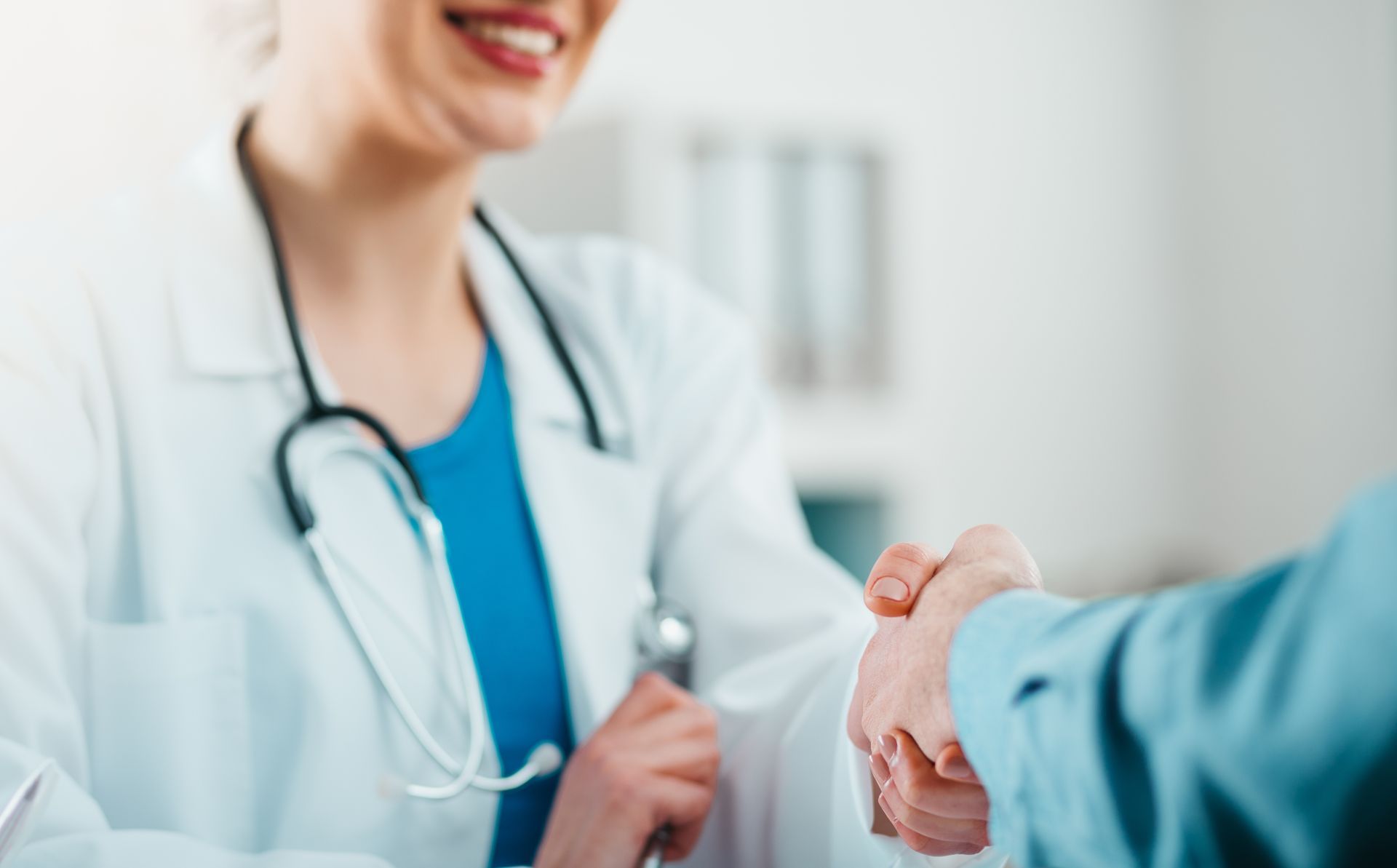 Doctor and patient shaking hands during a medical office appointment