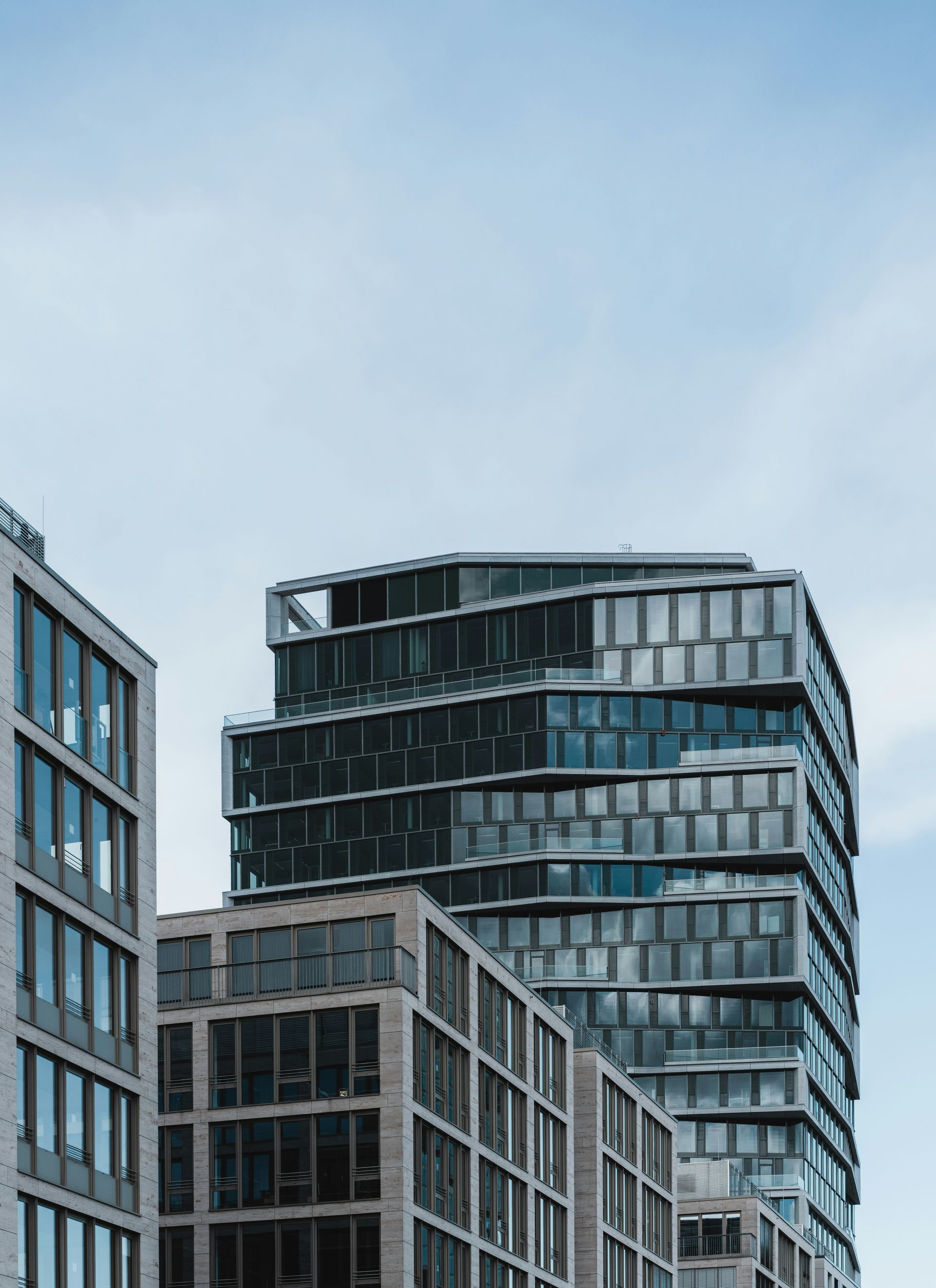 A row of tall buildings with a blue sky in the background
