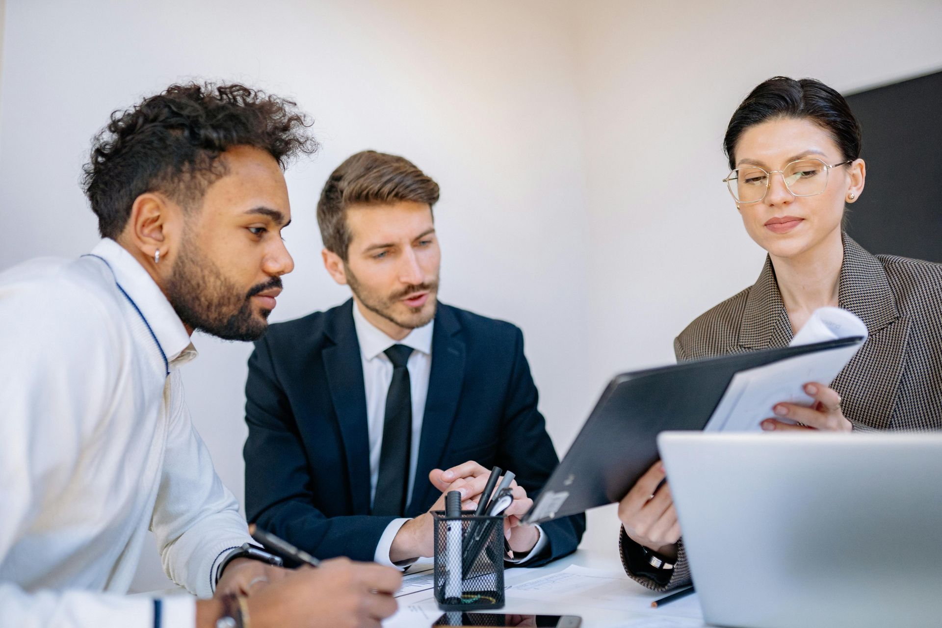 A group of business people are having a meeting in an office.