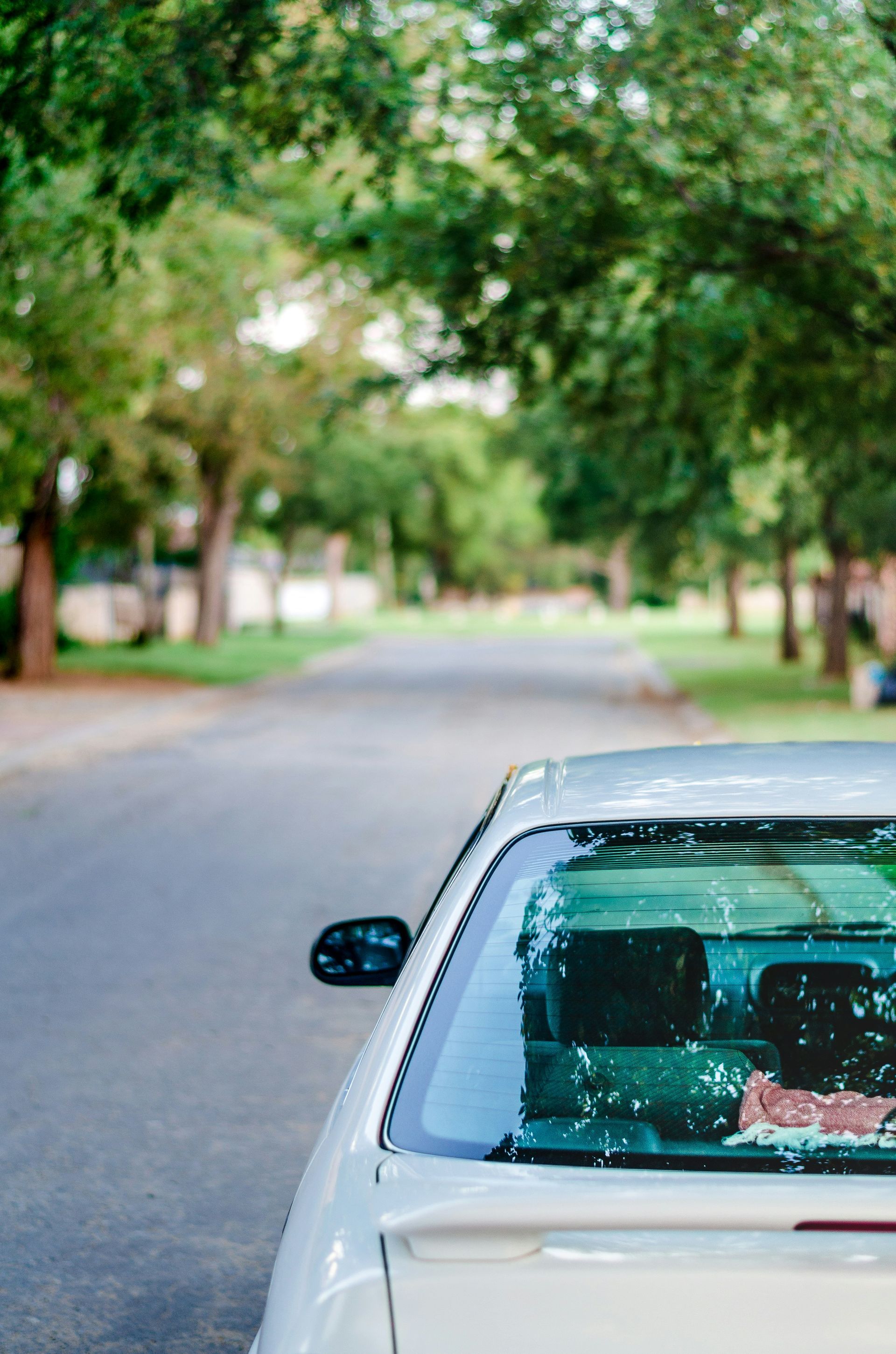 A white car is parked on the side of the road.