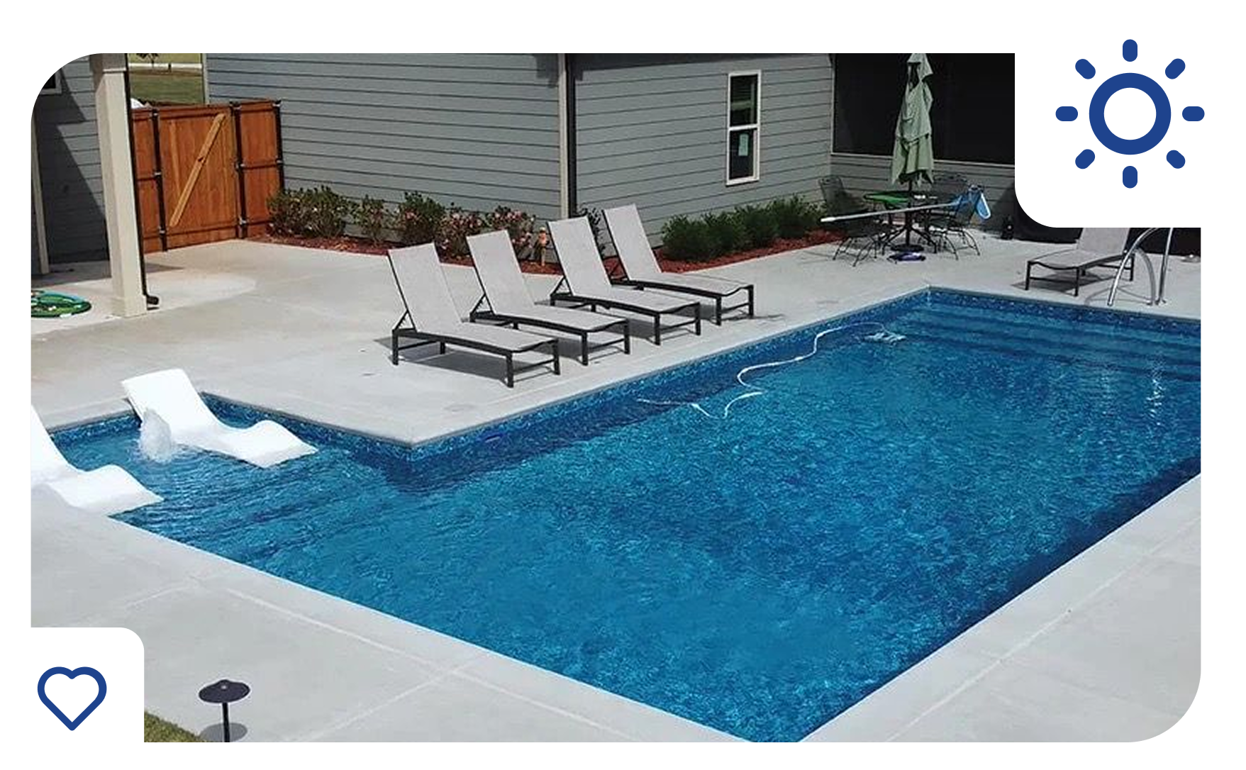 Swimming pool with lounge chairs, blue water, and backyard setting. Sunny day.