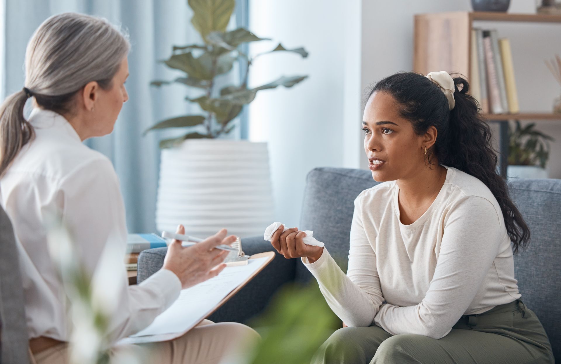 A woman is talking with a therapist.