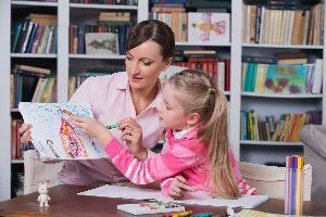 Teacher with Young Girl Making Artwork – Anchorage, AK – Counseling Solutions of Alaksa LLC