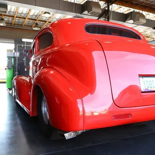a red car with a license plate that says fuel