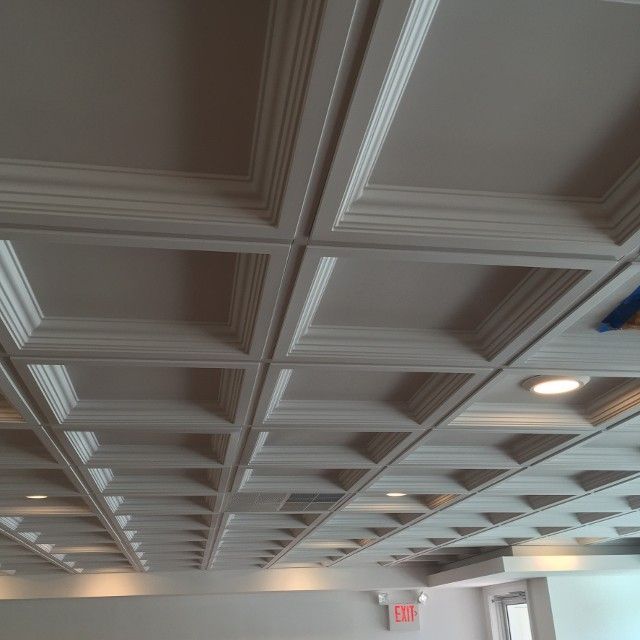 White coffered ceiling with recessed lighting.