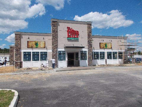Exterior view of a Silver Diner restaurant under construction on a sunny day.