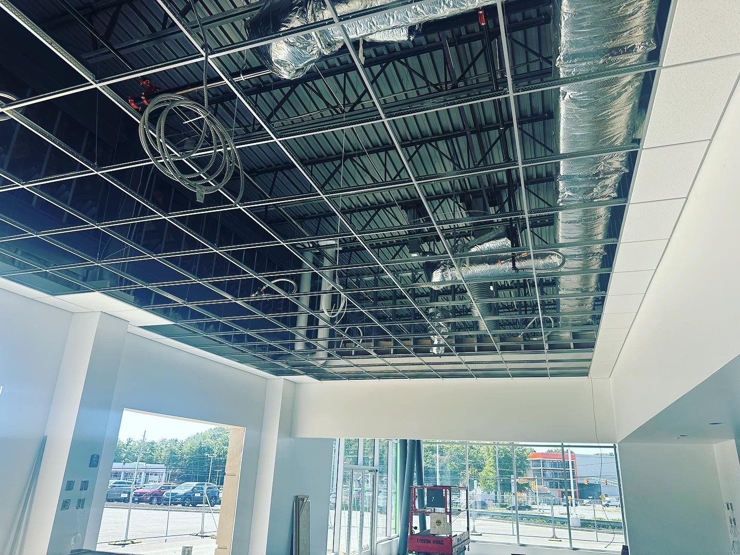 Interior view of a construction site. Exposed ceiling with metal grid and ductwork