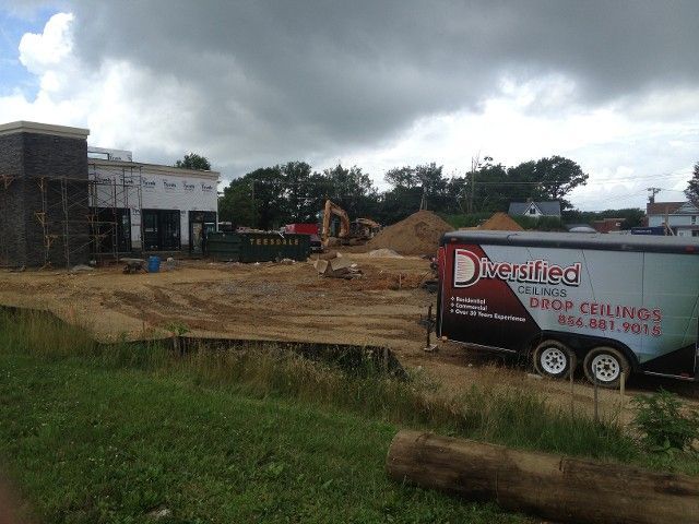 Construction site with a trailer for Reirsilied Drop Ceilings. 