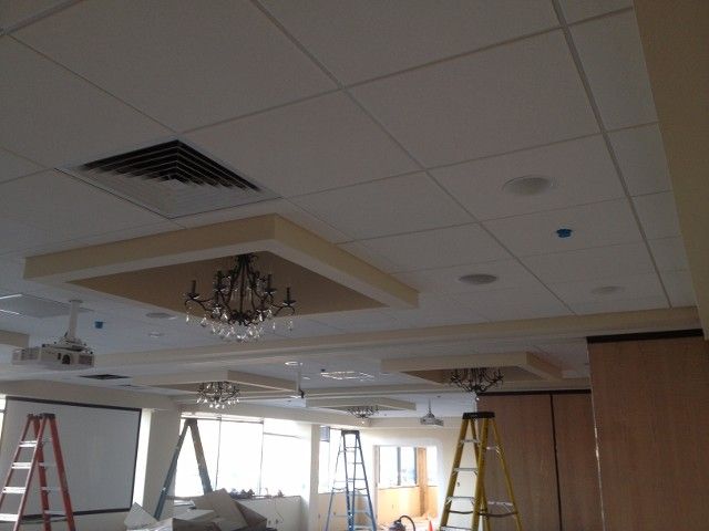 Conference room ceiling with lighting, ventilation, and construction equipment.
