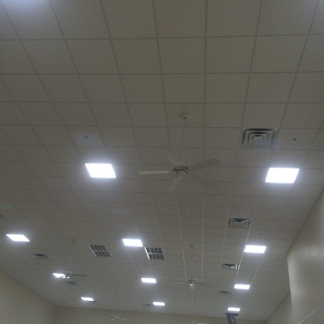 White ceiling with grid tiles, recessed lights, vents, and a ceiling fan.
