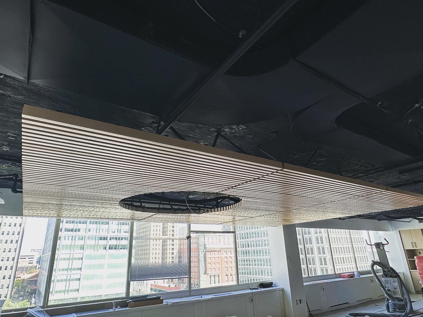 Interior ceiling with a decorative lighting panel and an open ceiling.