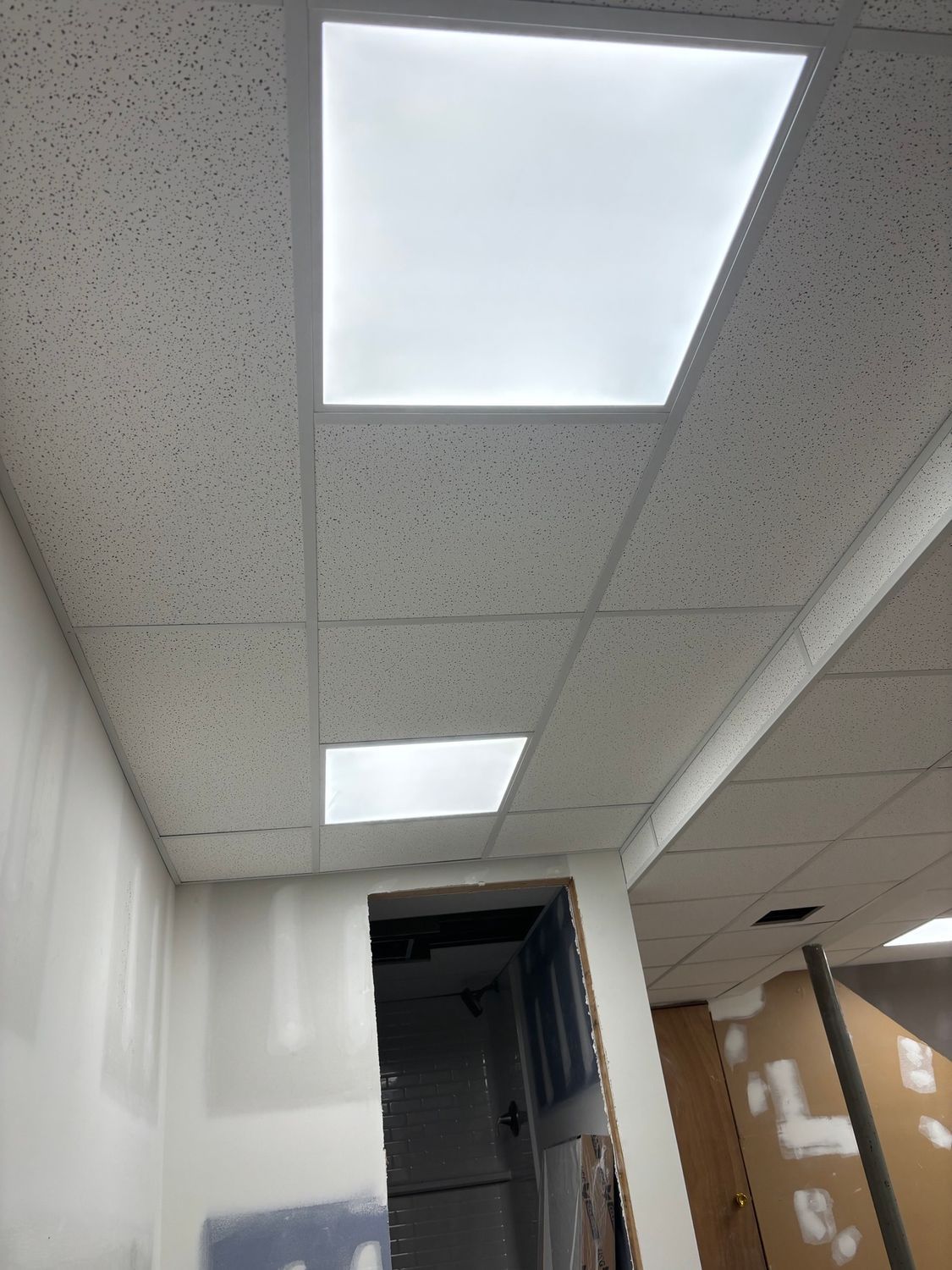 White office ceiling with recessed lighting. A doorway is partially visible.