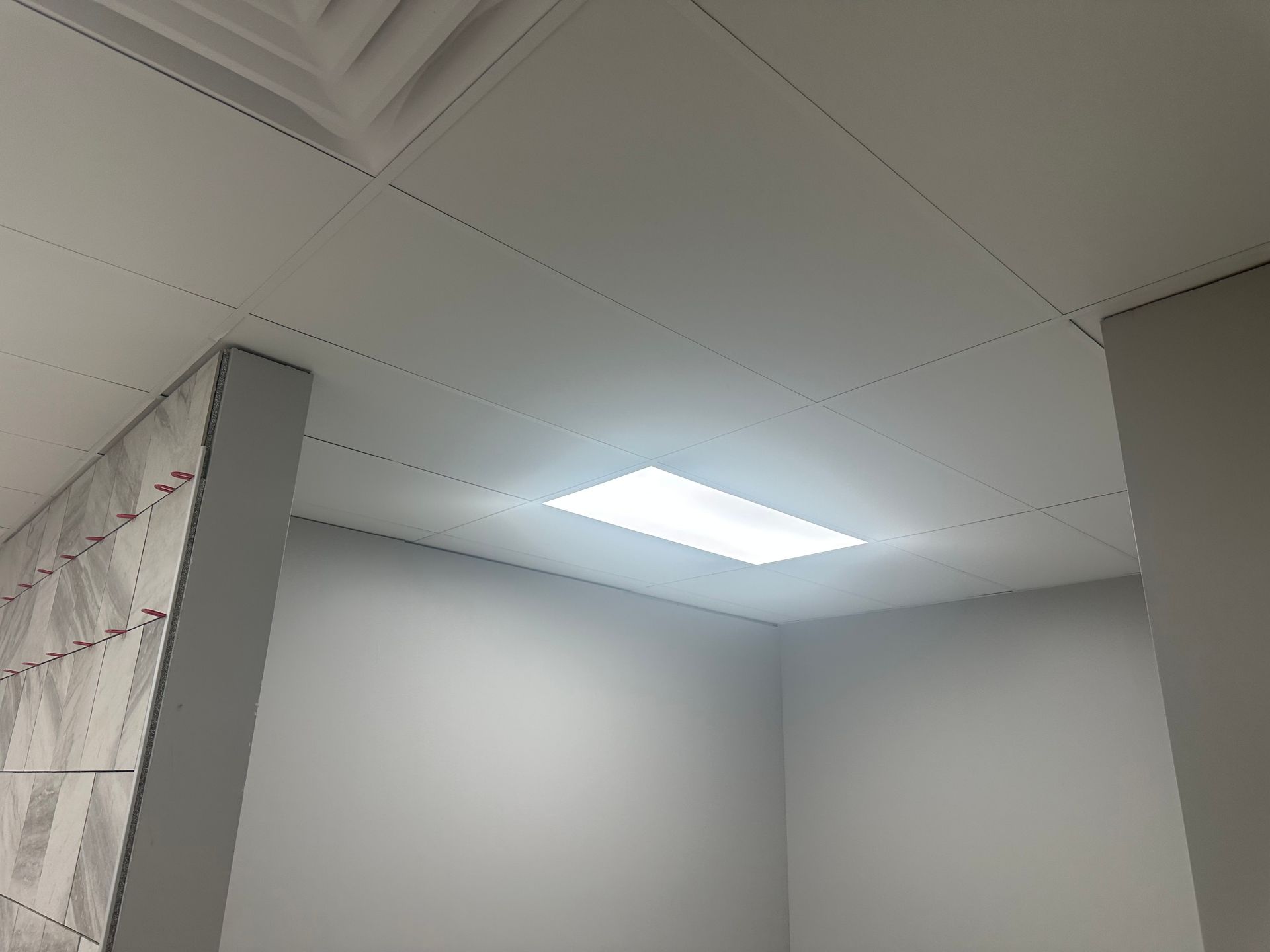 White ceiling with a rectangular recessed light, and light gray walls.