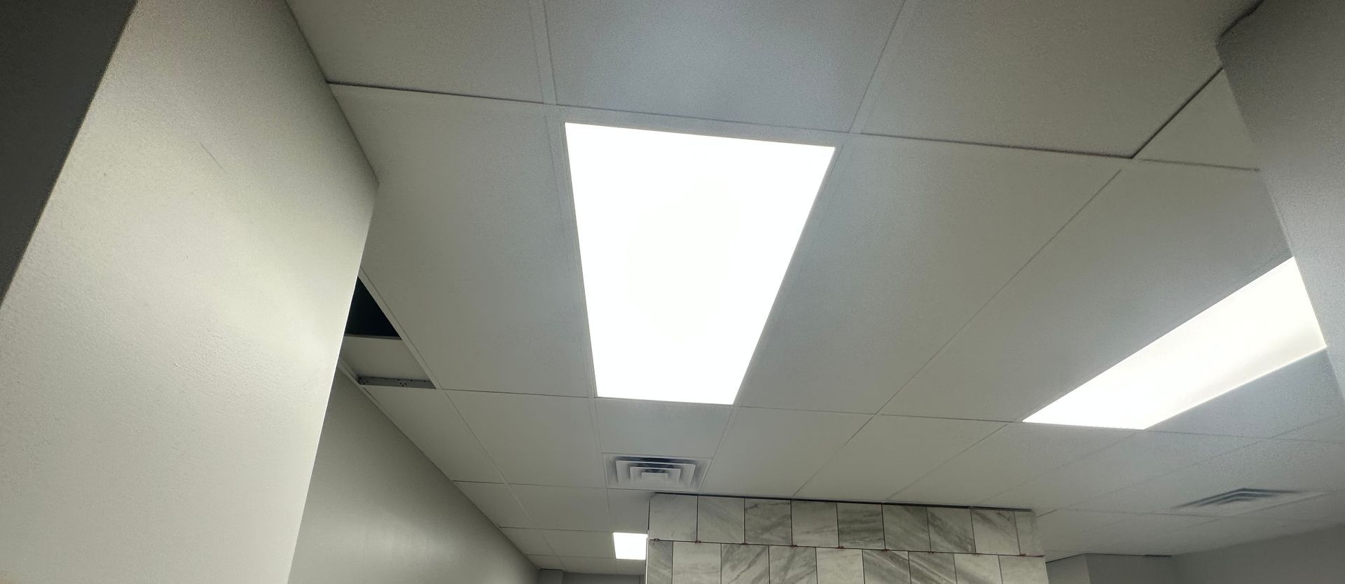 White ceiling with rectangular light fixtures.