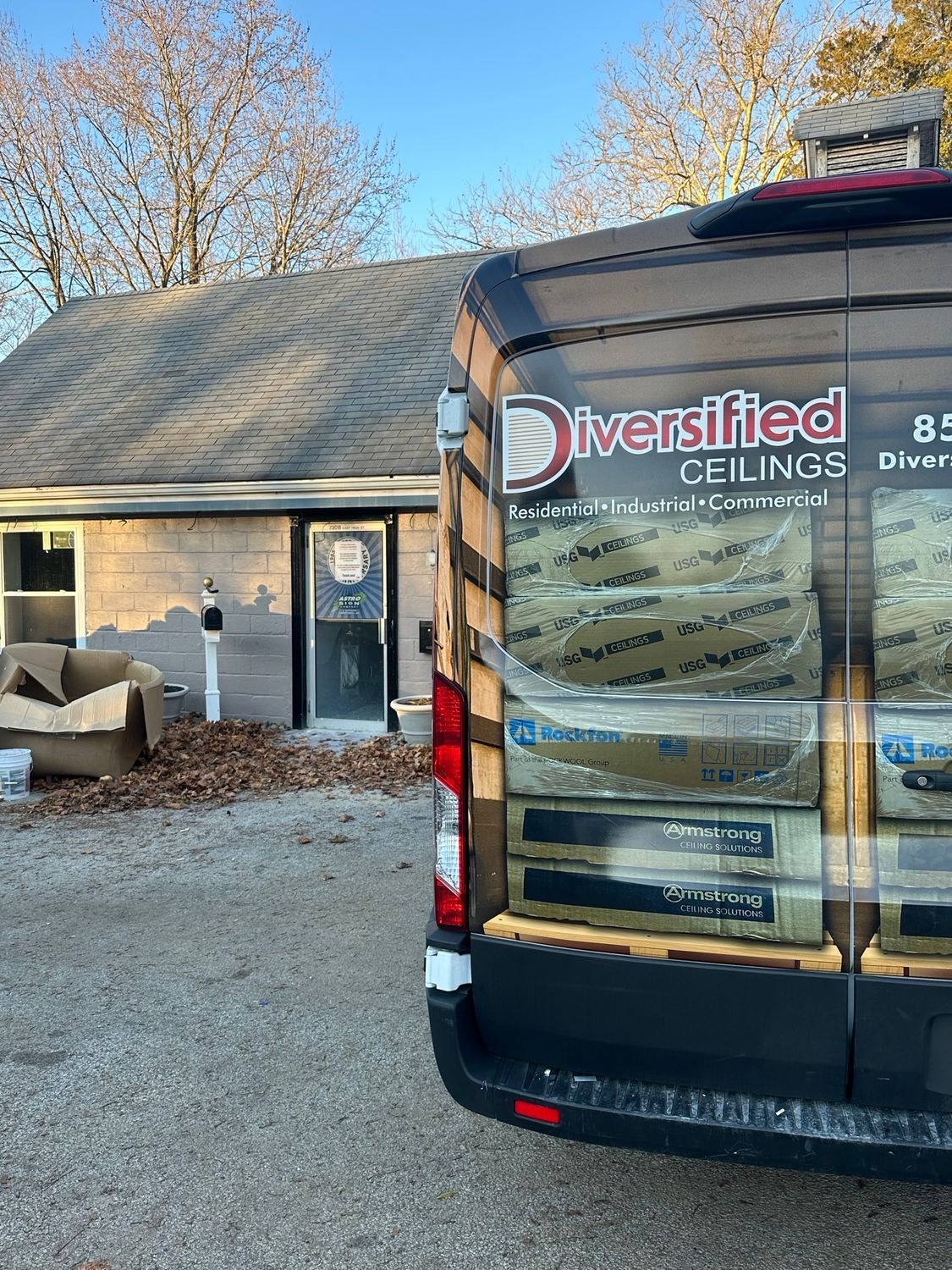 Van parked outside a small building, labeled 