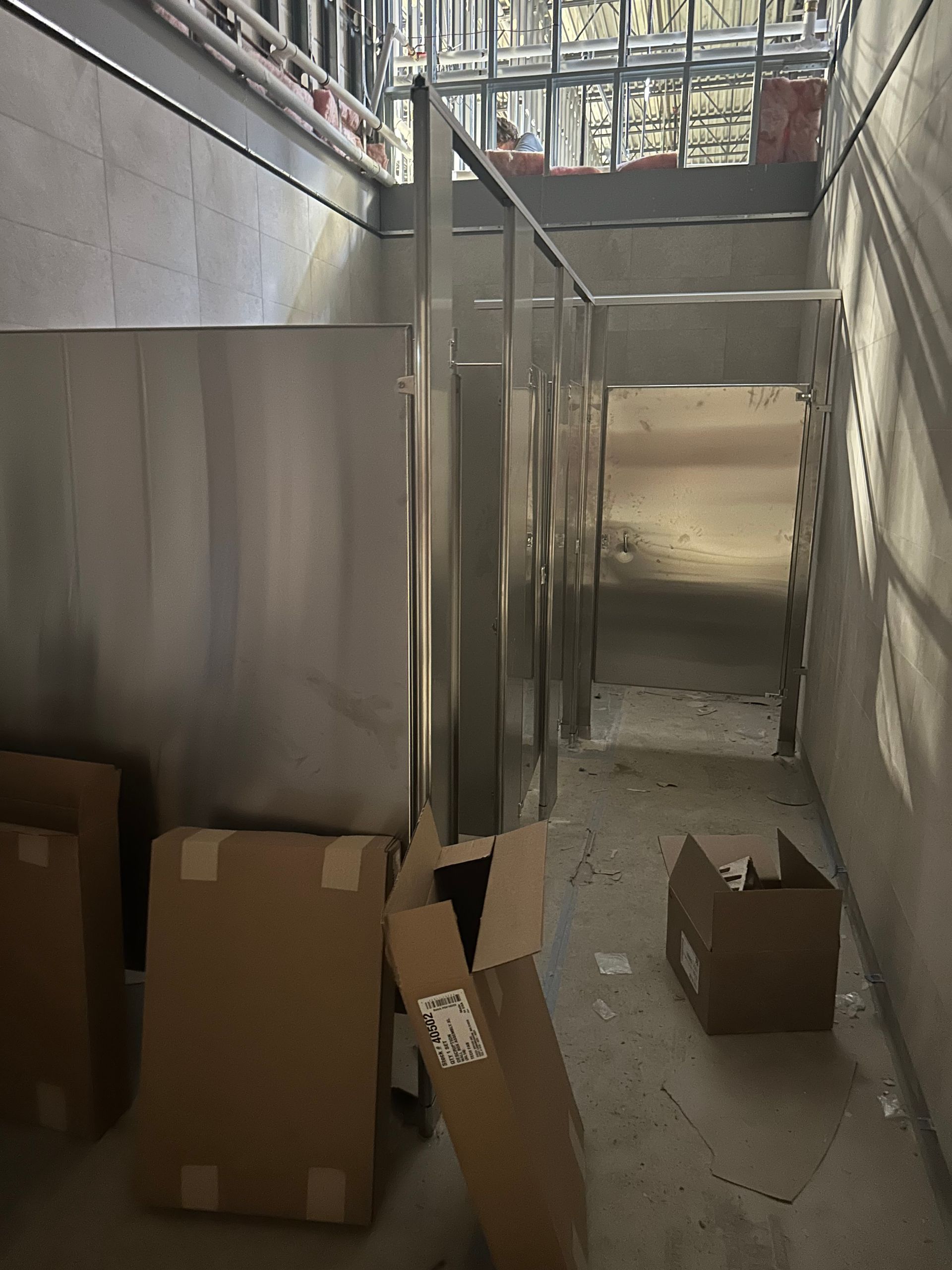 Construction site: metal studs, unfinished walls, cardboard boxes.