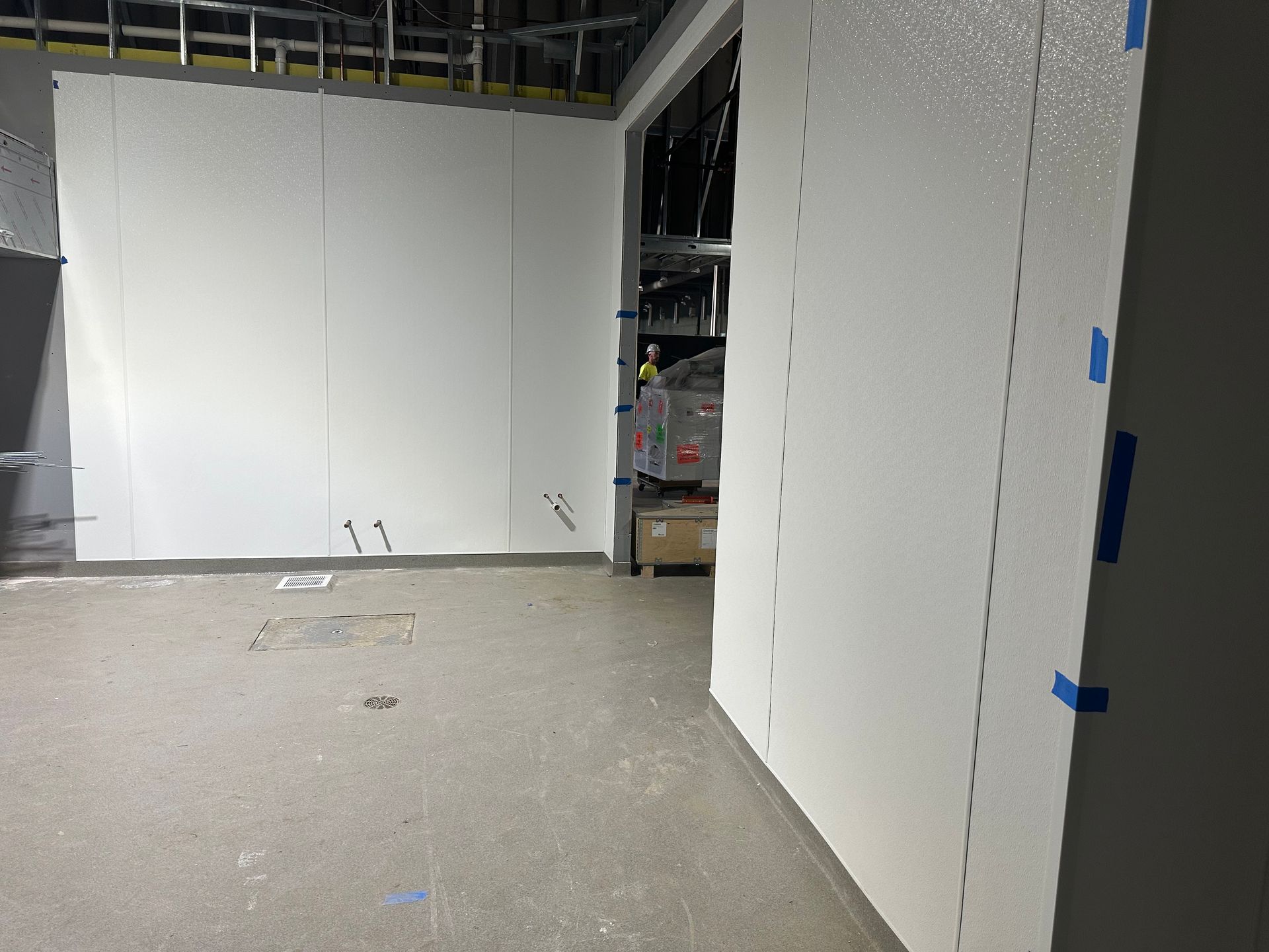 White interior construction with unfinished walls and concrete floor.