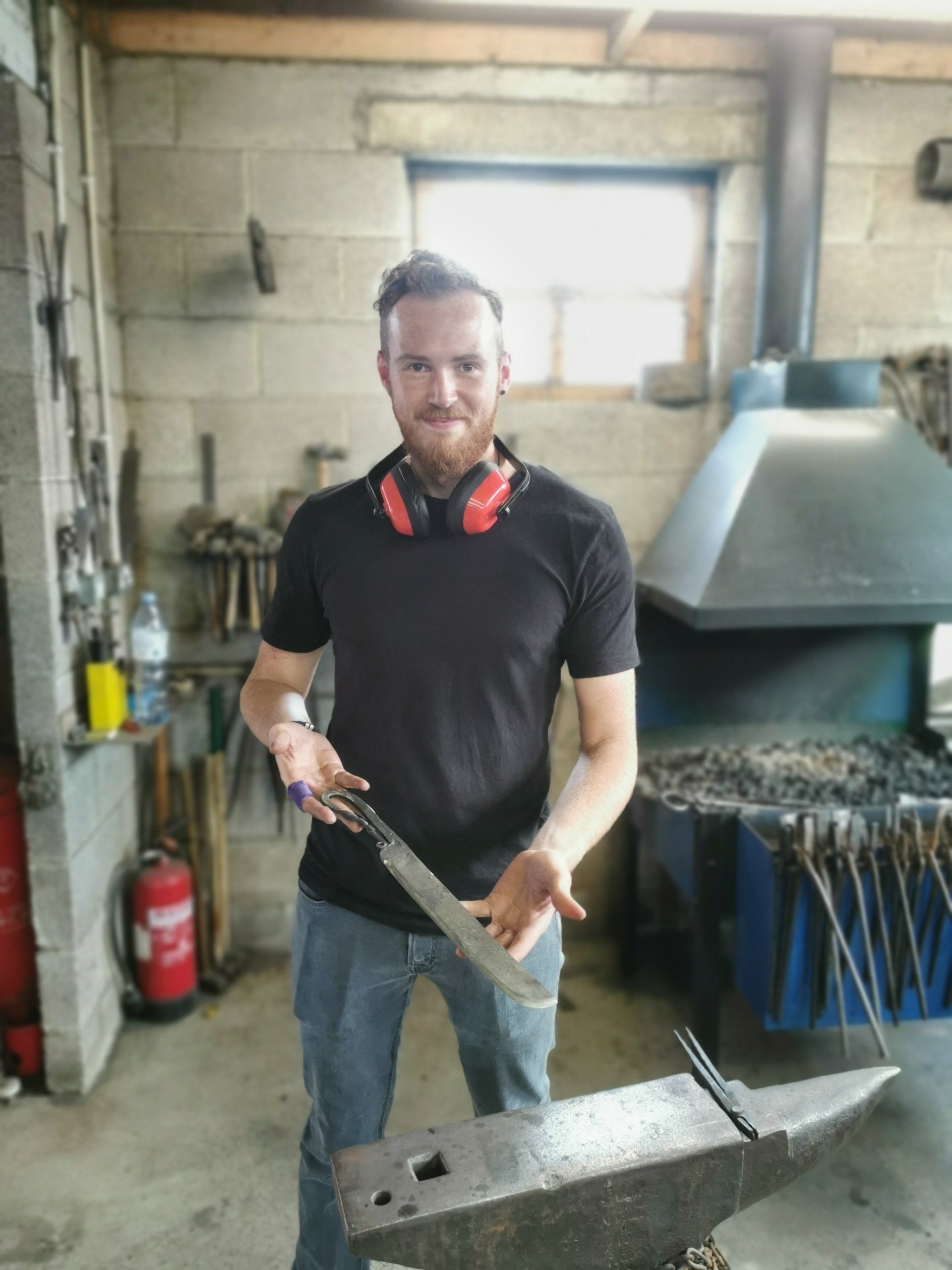 blacksmith student holding metal work
