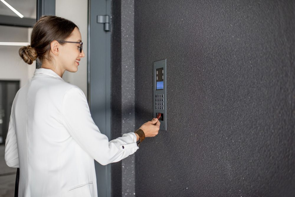 Young business woman in white suit touching — Locksmith in Carrara, QLD