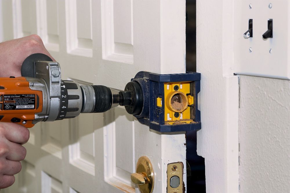 A Man is Installing a Dead Bolt for Added Security in Mermaid Beach, QLD