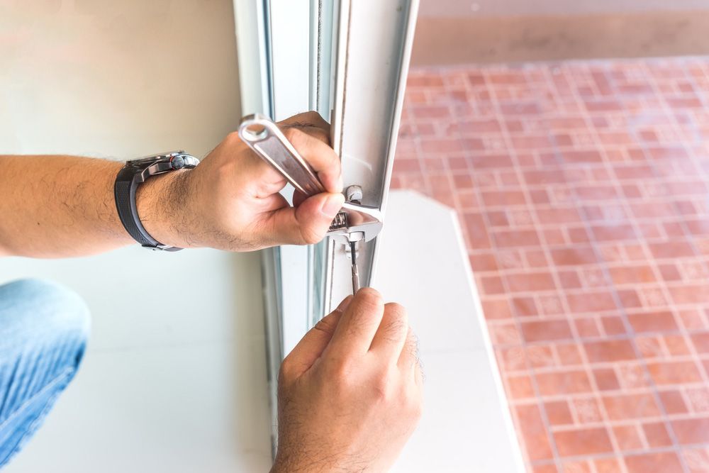 Locksmith try to repair old slide door — Locksmith in Southport, QLD