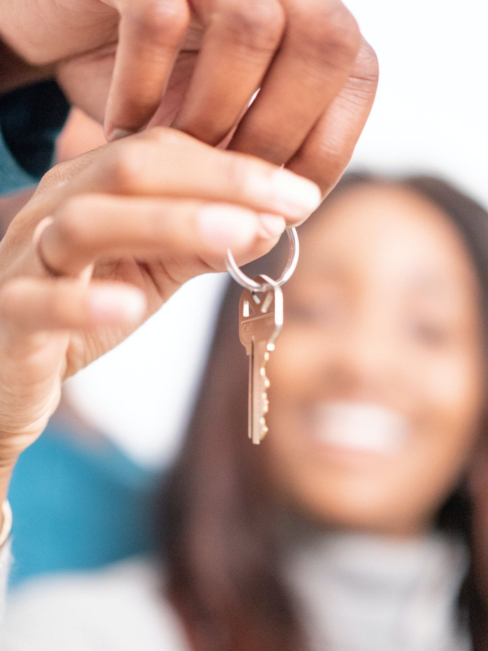 Woman holding a car key — Locksmith in Robina, QLD
