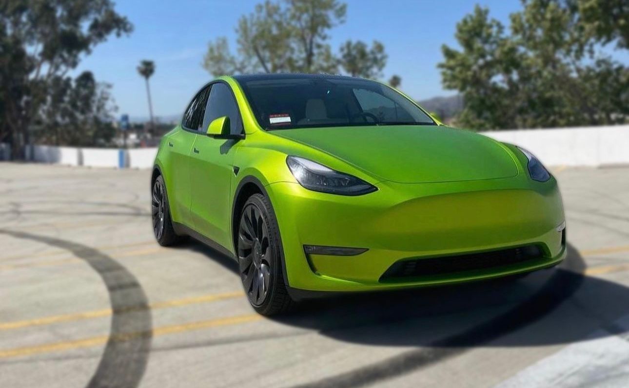 Eye-catching neon green Tesla Model Y transformed by XWRAPS, top car wraps LA specialist, showcasing bold customization under Los Angeles sun