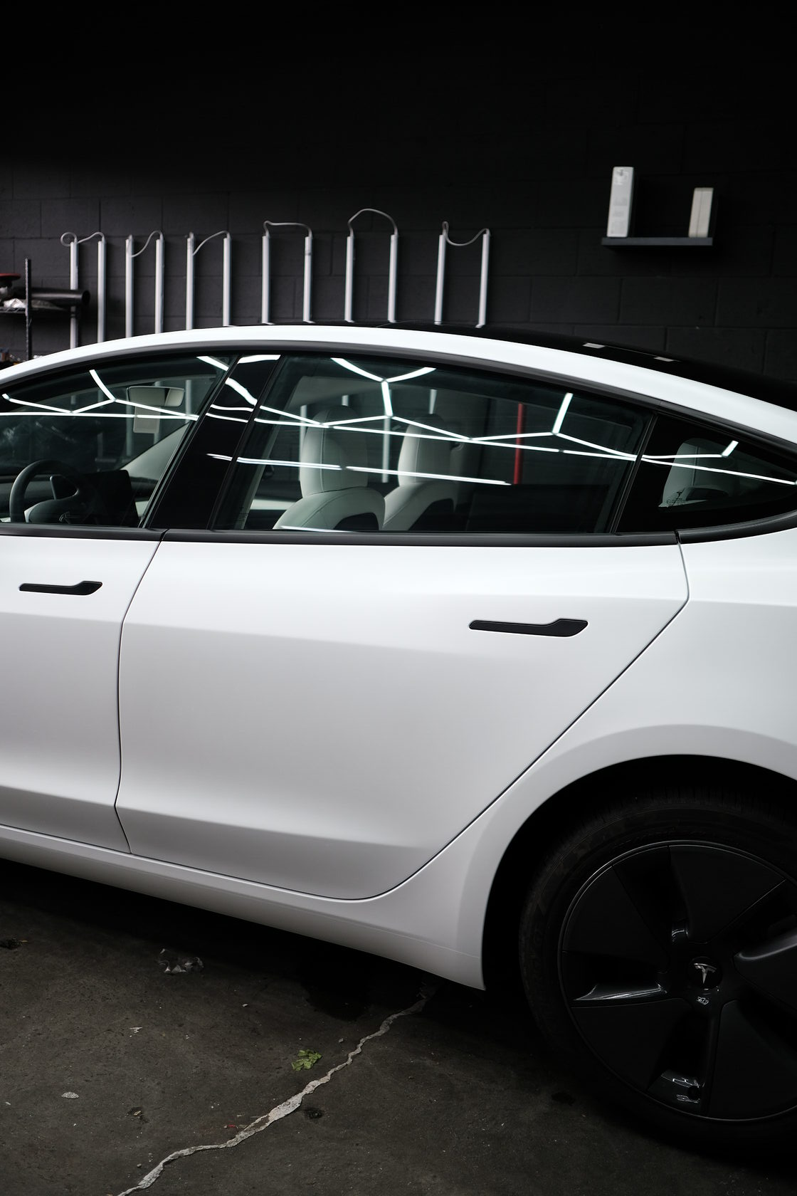 Tesla Model 3 side profile showcasing precision car wraps LA by XWRAPS Los Angeles, featuring pristine white finish