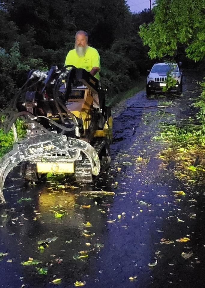 A man is driving a tractor down a road