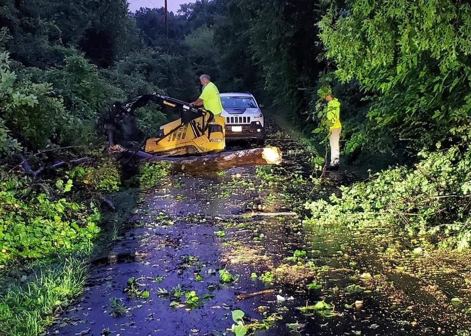 A jeep is parked on the side of a flooded road