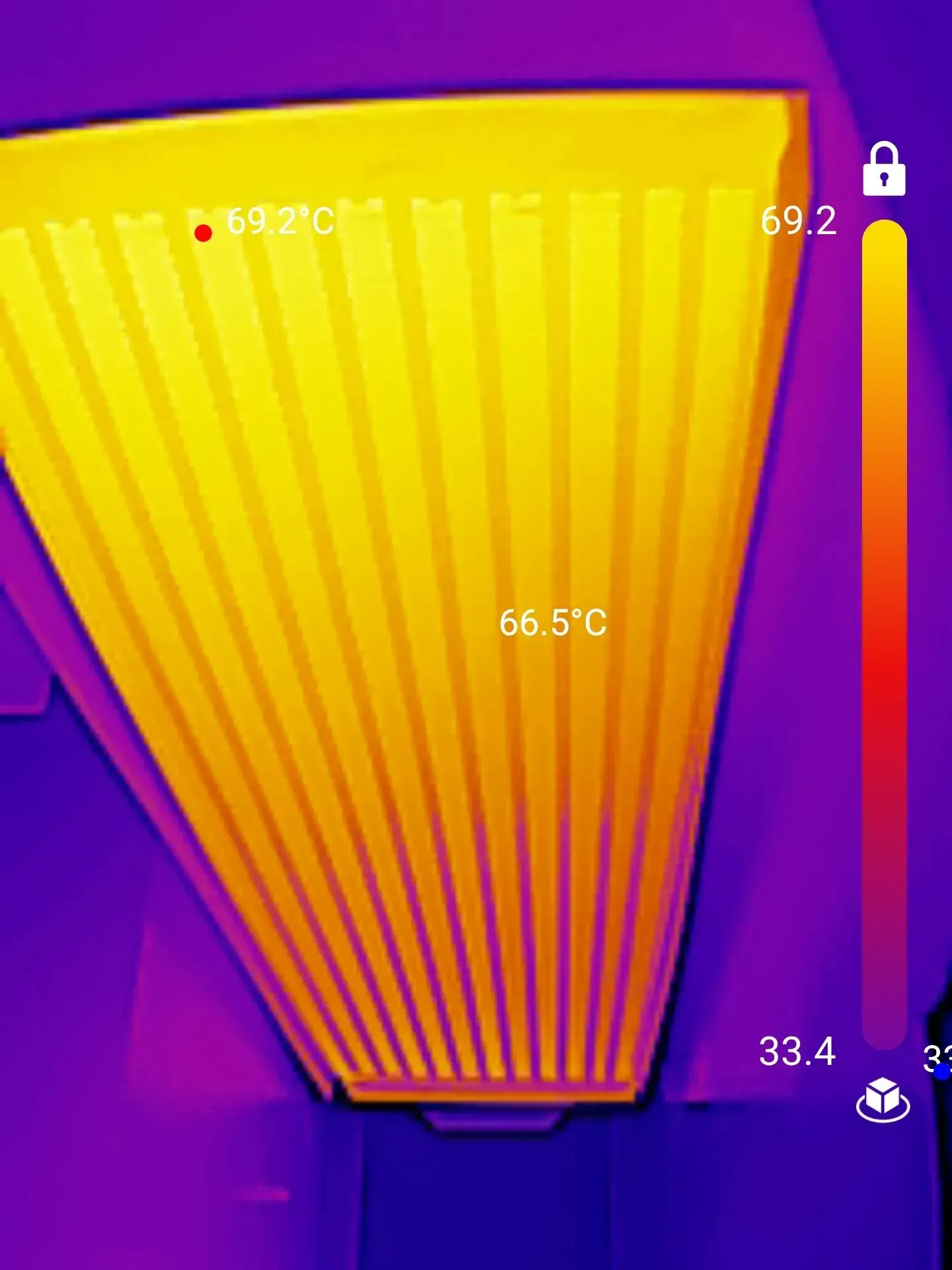 Thermal image of a yellow, heat-emitting object, likely an appliance, with temperatures ranging from 33.4°C to 69.2°C.