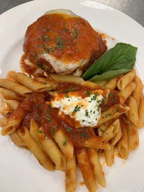 Chicken parmesan with pasta and tomato sauce.