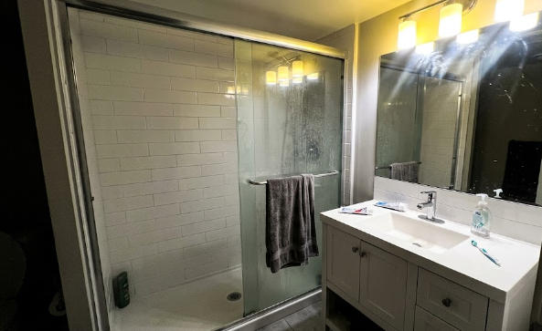 A newly finished basement bathroom with a walk-in shower.