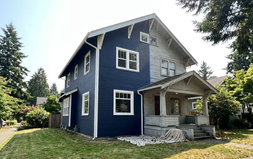 Exterior house painting transformation of a classic Craftsman home in Spokane.