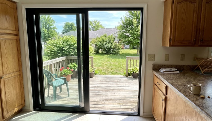Modern sliding glass patio doors installed in a Spokane home, letting in beautiful natural sunlight and connecting the kitchen to the backyard.