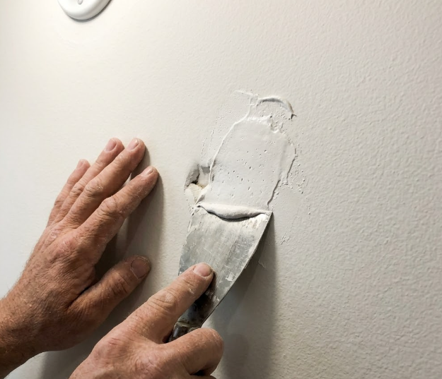 Spokane General Contractor repairing drywall flaws before interior home painting.