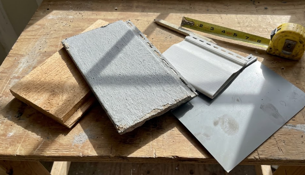 Different siding materials for homes including fiber cement, vinyl, wood, and metal samples.
