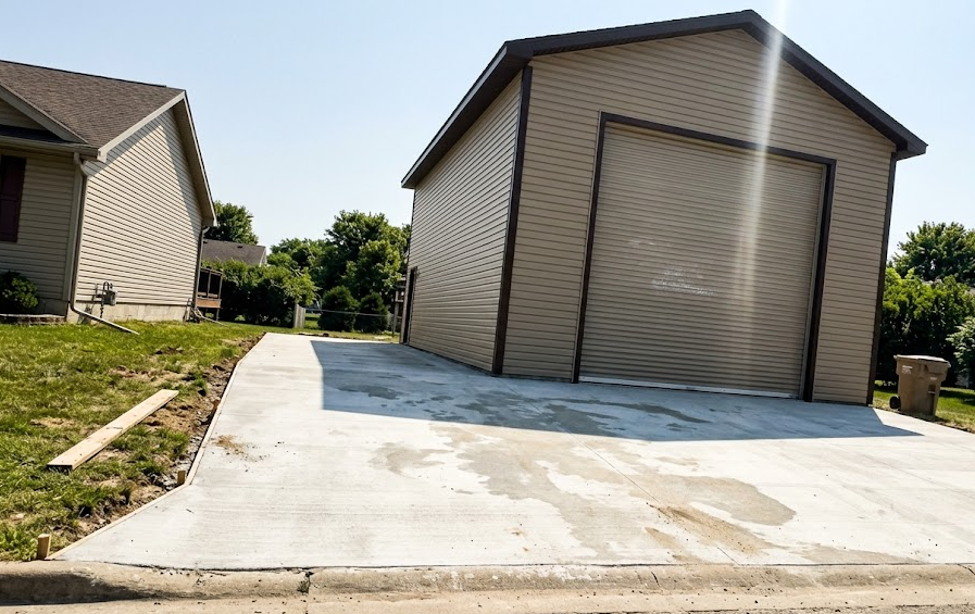 A tall, custom-built RV storage garage with a 14-foot overhead door located on a residential property in Spokane WA.