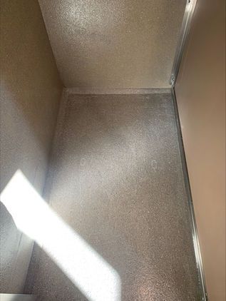 Empty beige cardboard box interior with a bright diagonal beam of sunlight on the floor