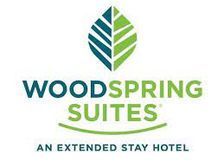 WoodSpring Suites logo with green and blue leaf icon and the words “An Extended Stay Hotel”