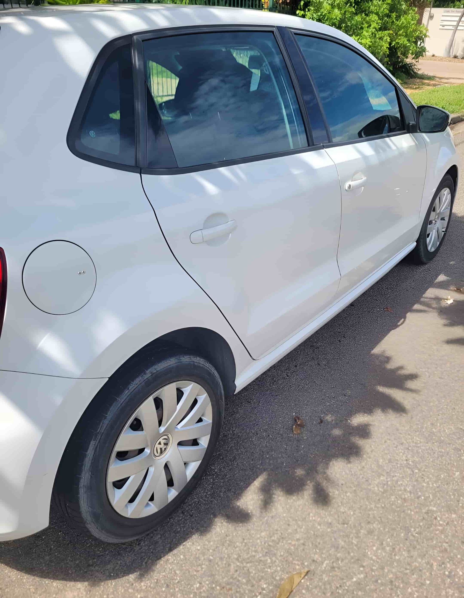 A White Car is Parked on the Side of the Road — Dek-A-Dent Townsville In Wulguru, QLD