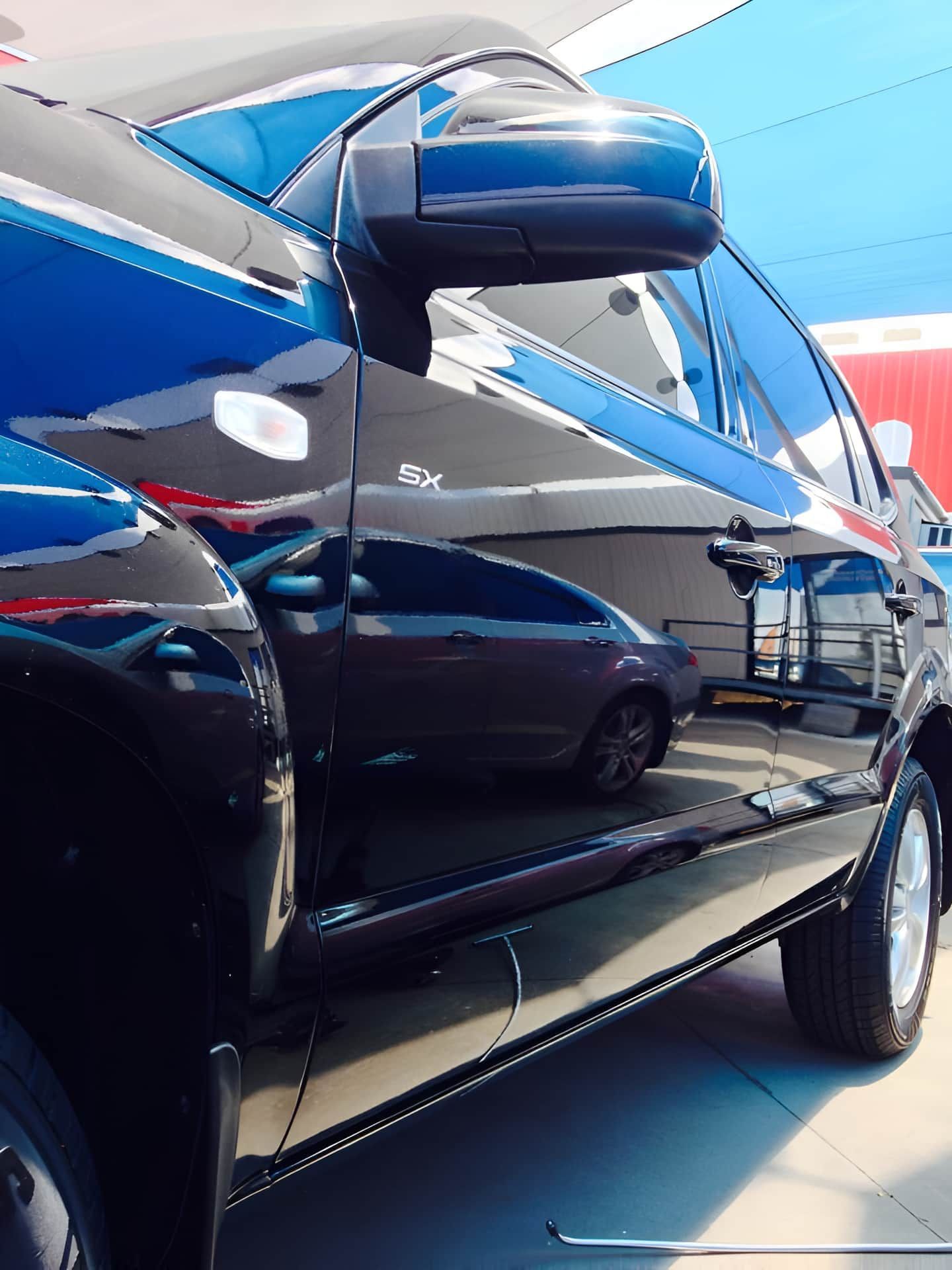 A Black Car is Parked in a Parking Lot With Other Cars — Dek-A-Dent Townsville In Wulguru, QLD