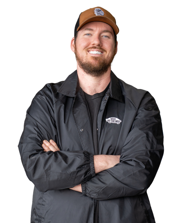 A man with a beard is wearing a hat and a black jacket.