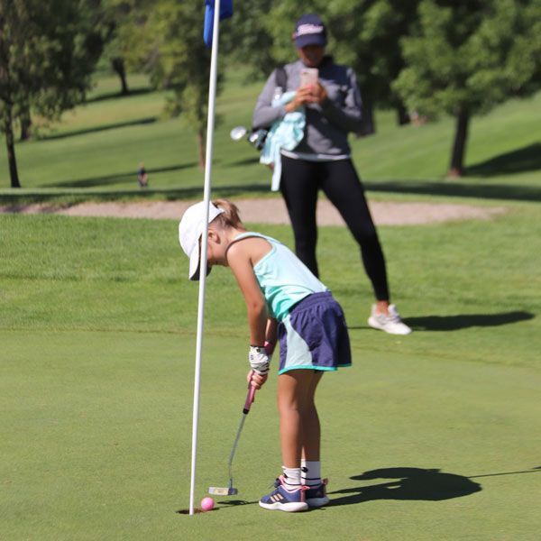 little girl playing golf