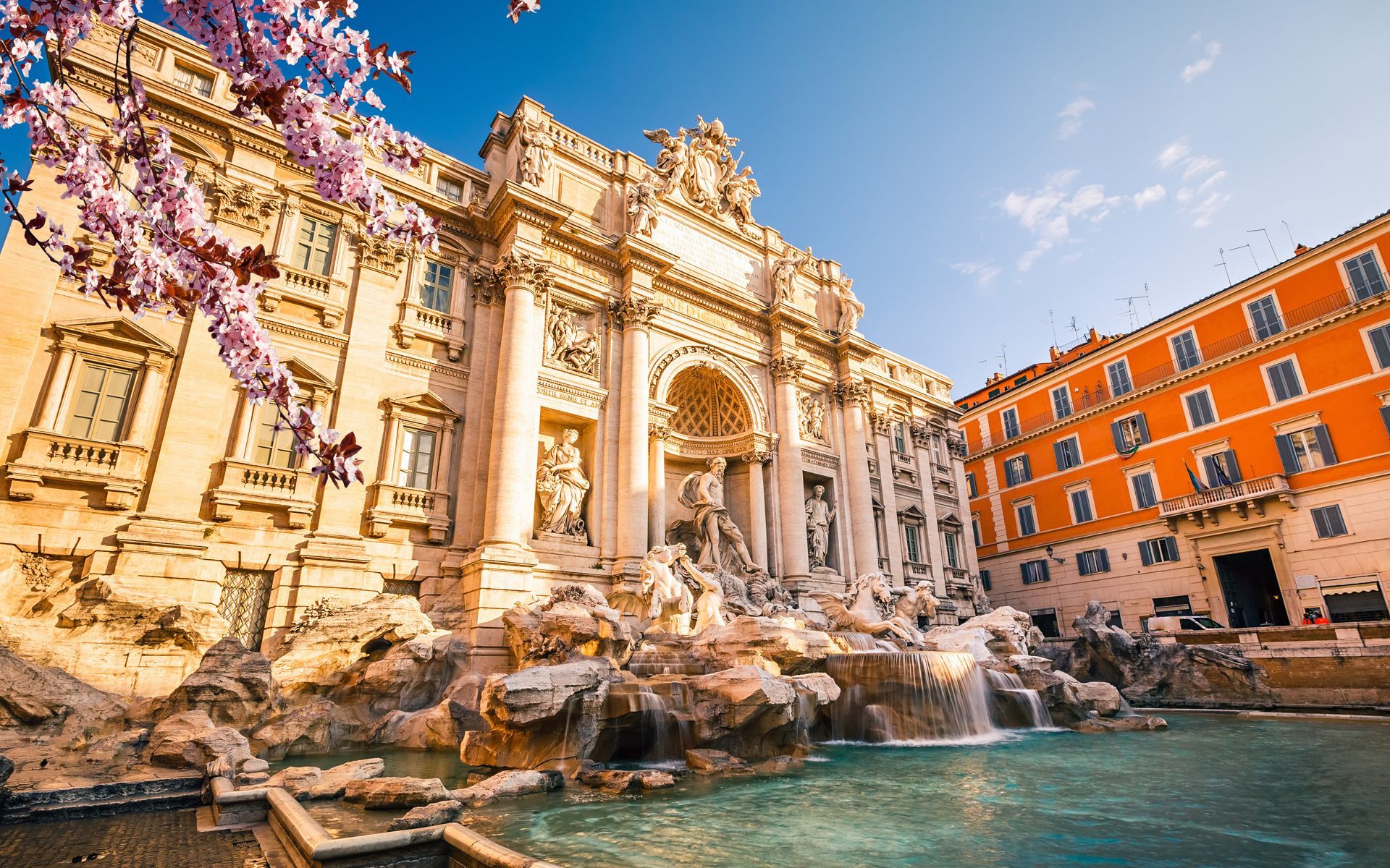 A large building with a fountain in front of it.