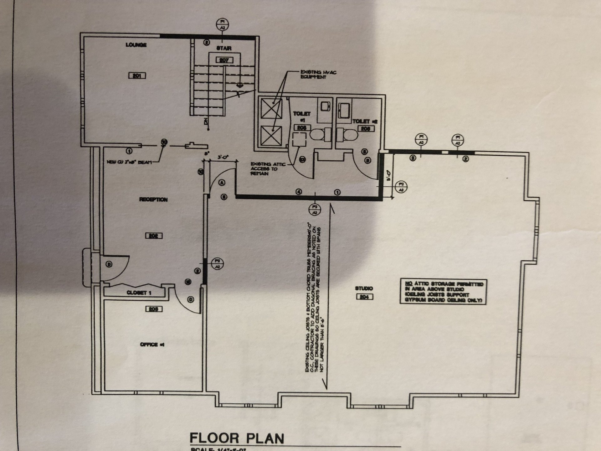Floor plan of a commercial building; includes office spaces, a restroom, and a staircase.
