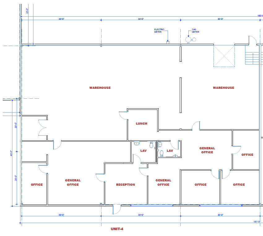 Floor plan of a commercial building layout: warehouse spaces, offices, reception, and restrooms.
