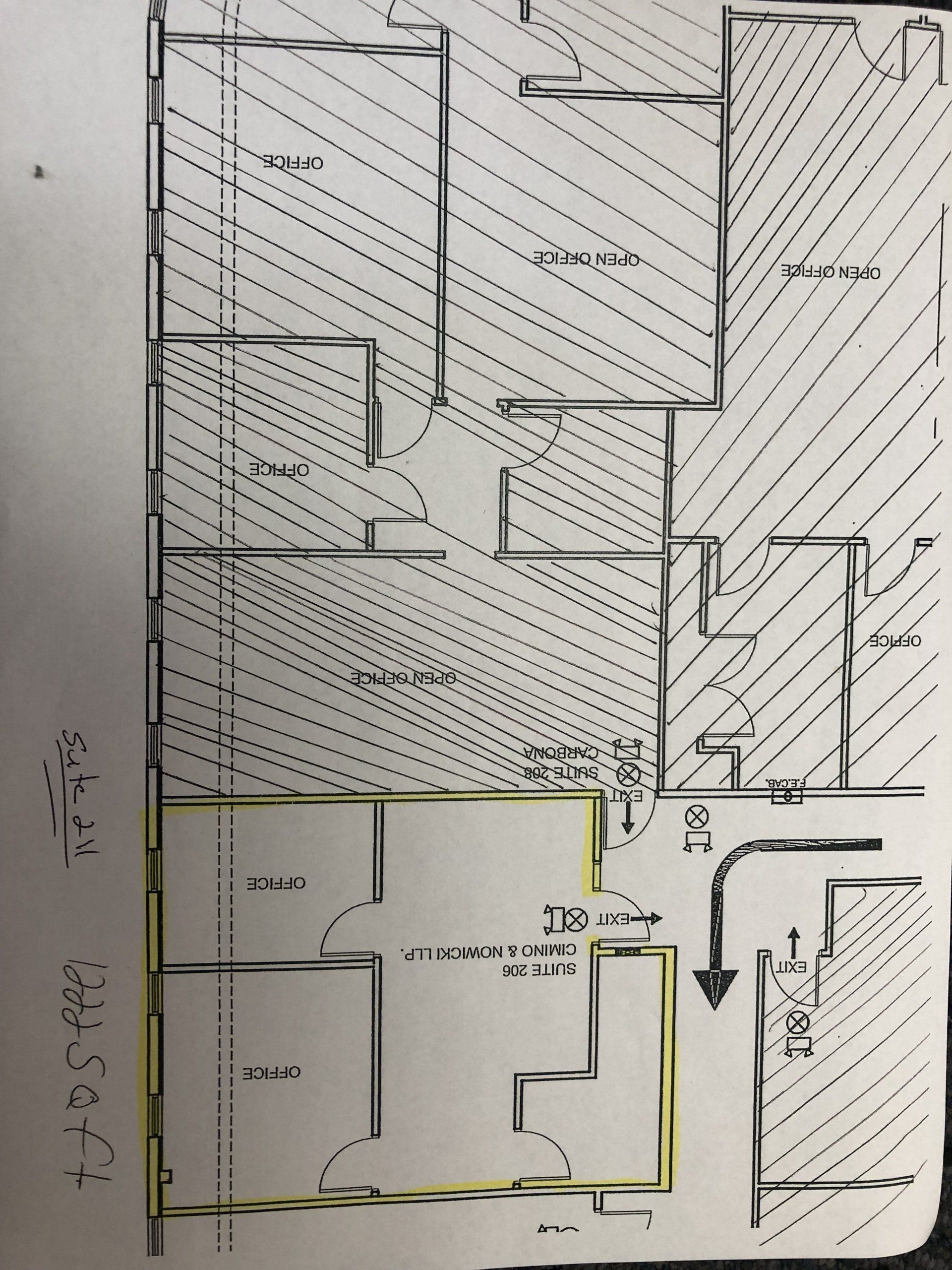 Floor plan sketch with room layouts, shaded areas, doors, and a directional arrow.